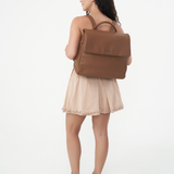 Model wearing Camel Bare Leather Lottie Backpack on her back. Front