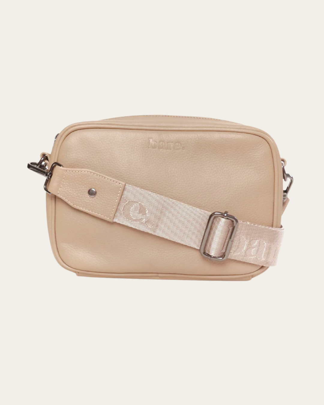 Stone Bare Leather crossbody bag with a nylon strap on a light beige background