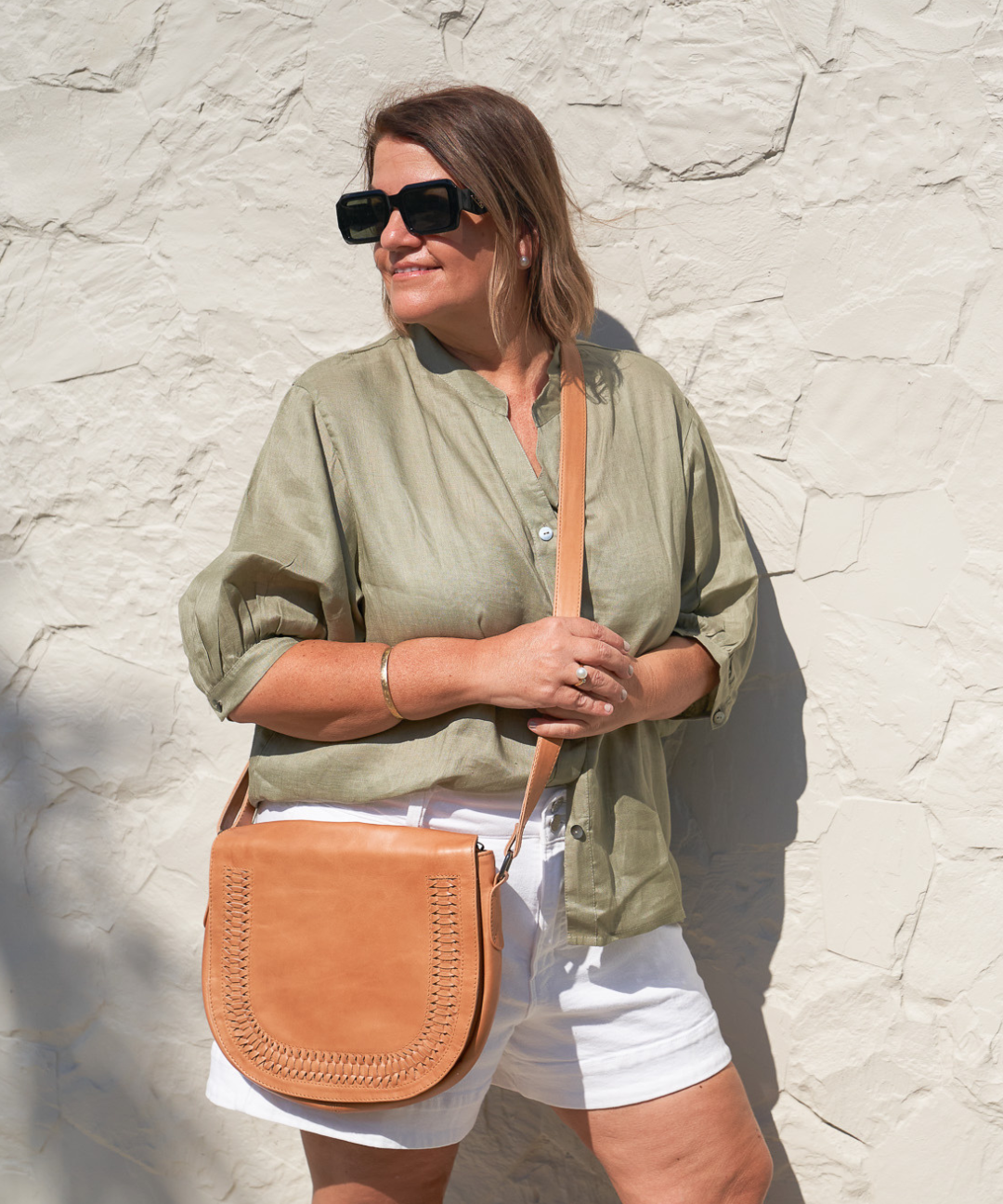 Model posing with Bare Leather Harper bag in Almond