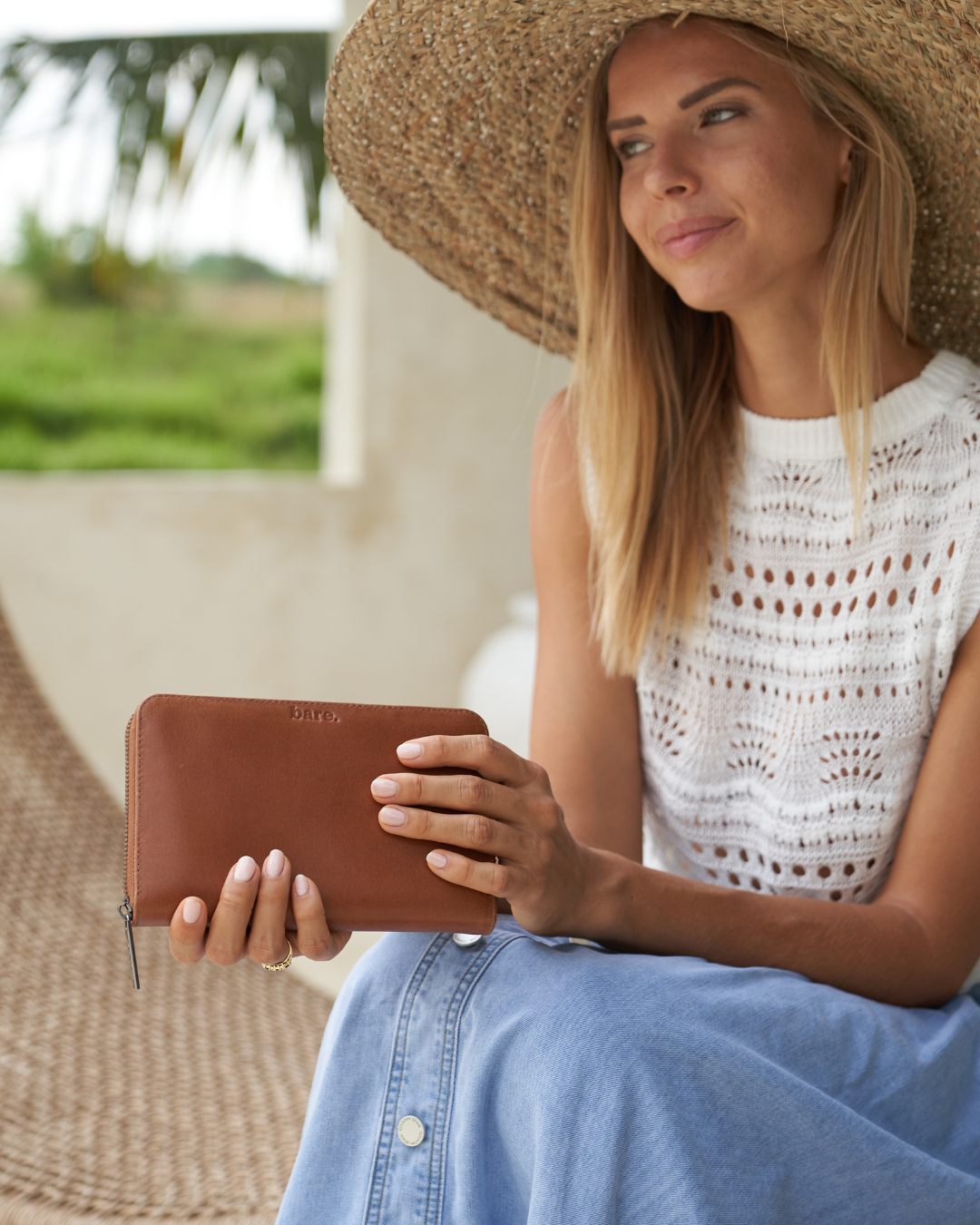 Model holding a Camel Bare Leather wallet