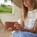 Model holding a Camel Bare Leather wallet
