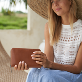Model holding a Camel Bare Leather wallet