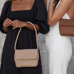 Models holding a Stone and Camel Bare Leather Patsy Bag.