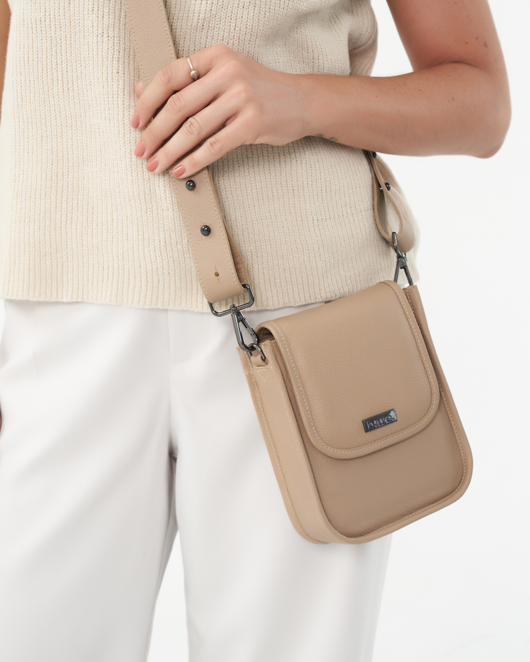 Model wearing Stone Bare Leather bag as a crossbody bag. Front