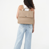 Model with the Stone Bare Leather Lottie Backpack on her back. Front
