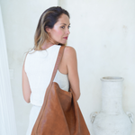 Model wearing the Camel Bare Leather Lulu bag on her shoulder.