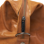 Image is of the zip and hardware on a Camel Bare Leather Travel Bag 