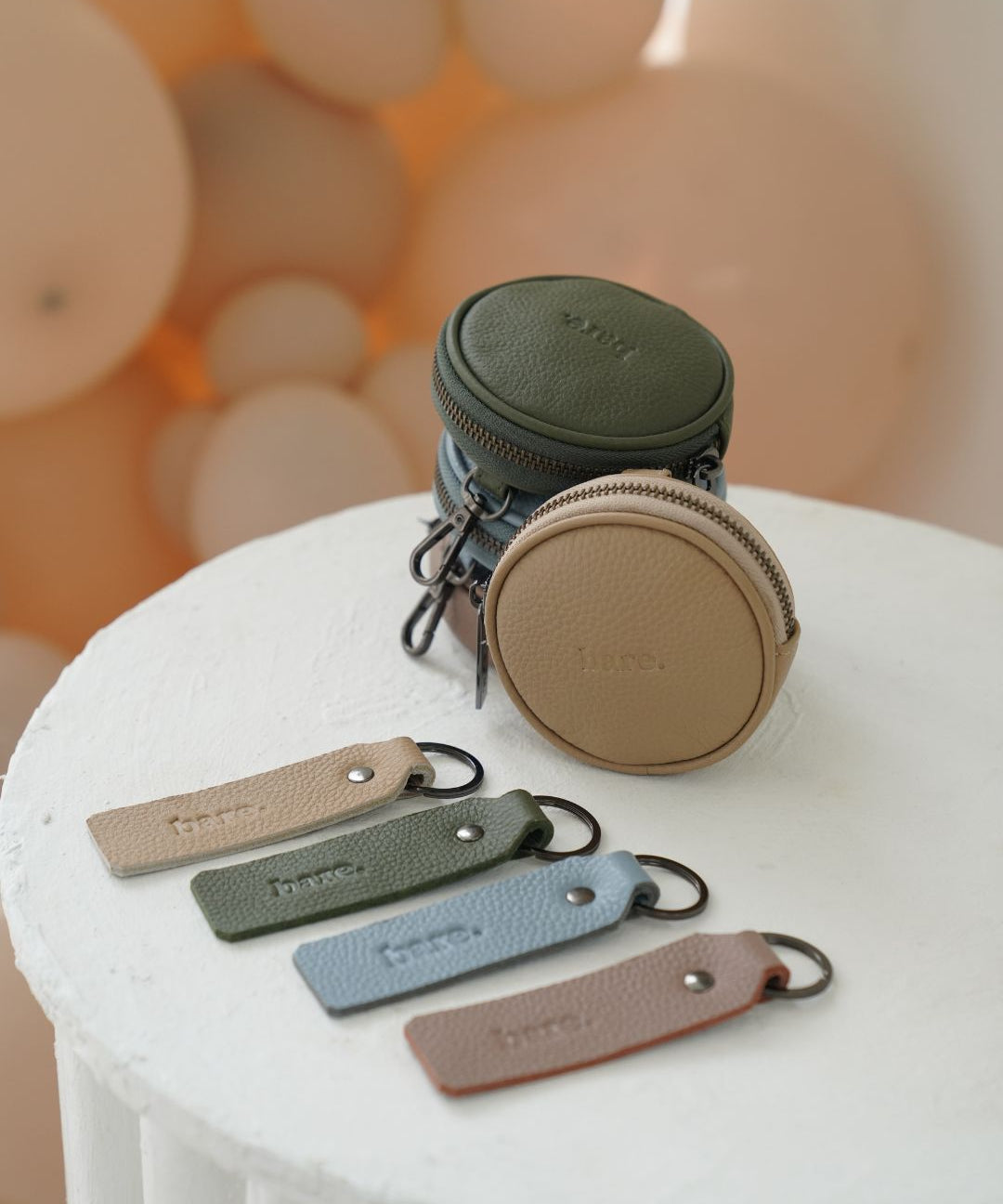 Four colourways of the Bare Leather Coin Pouch and Key Ring. Mocha, Olive, Stone and Powder Blue