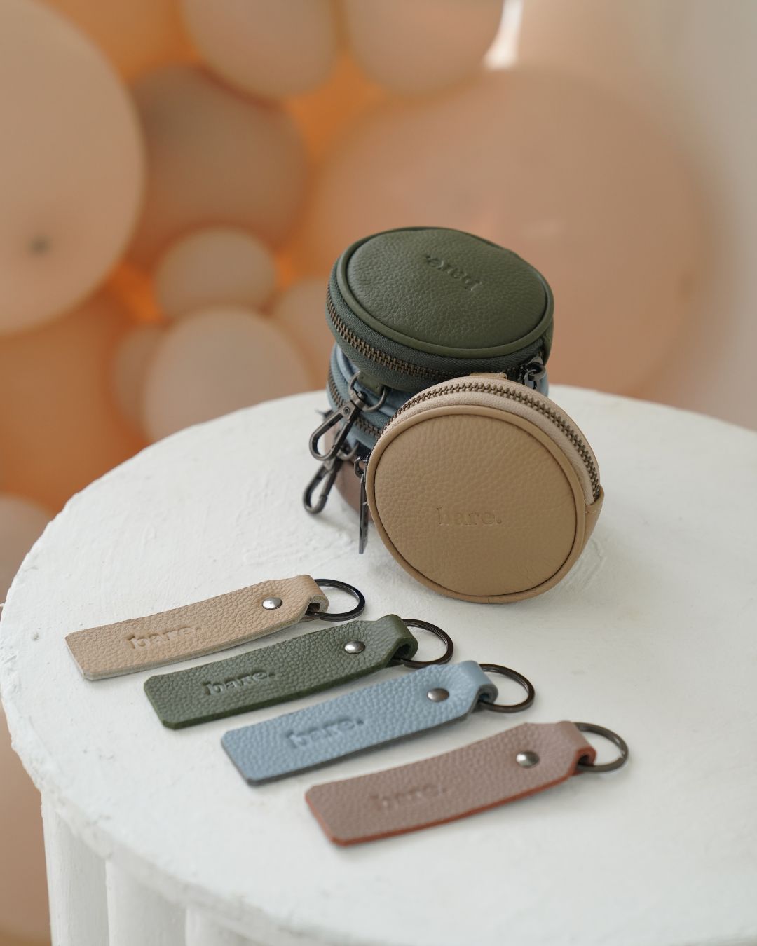 Four colourways of the Bare Leather Coin Pouch and Key Ring. Mocha, Olive, Stone and Powder Blue