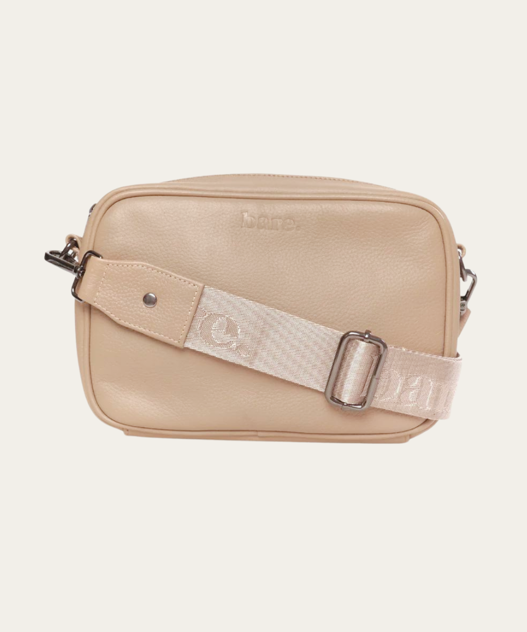 Stone Bare Leather crossbody bag with a nylon strap on a light beige background