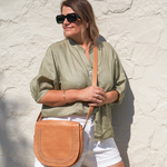 Model posing with Bare Leather Harper bag in Almond