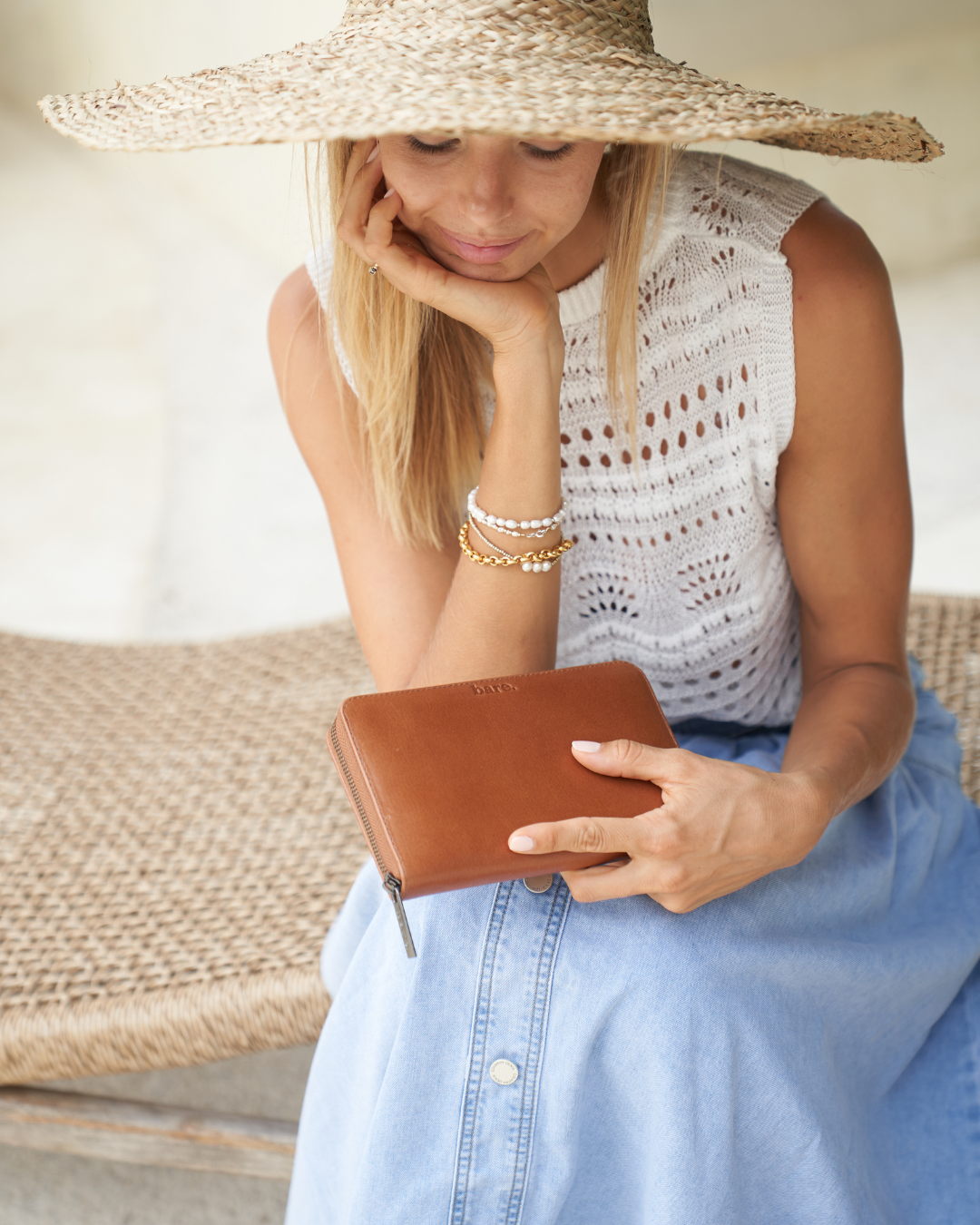 Model holding a Camel Bare Leather Quinn Wallet